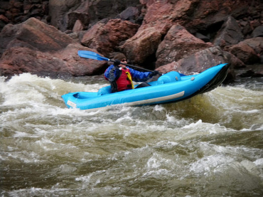 woman in river rafting over rapids