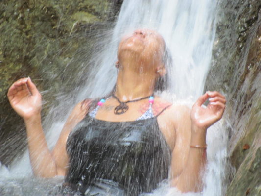 woman under a waterfall, nature, women's empowerment workshop