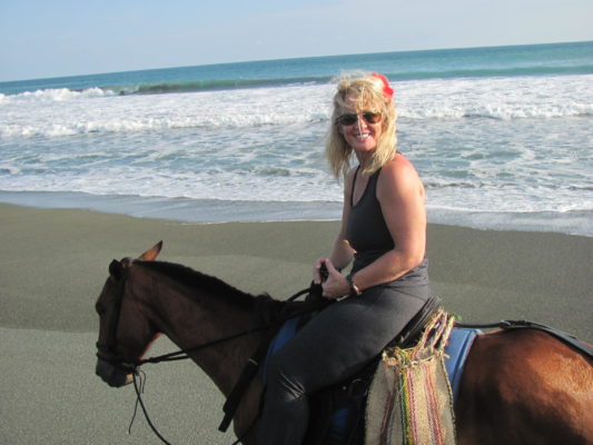 woman riding horse on beach, cindy, facilitator, women's empowerment workshop