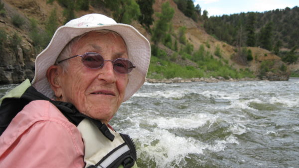 older woman on rafting trip, enjoying river, women's empowerment workshop